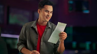Guy reading a bet slip